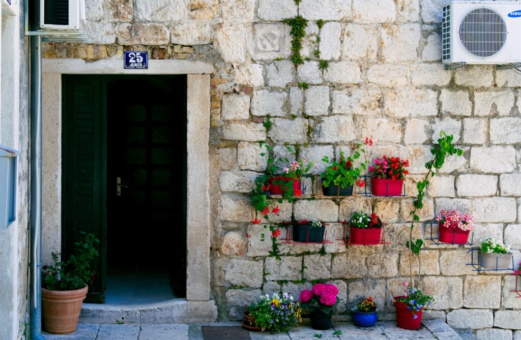 green wooden door with red flowers