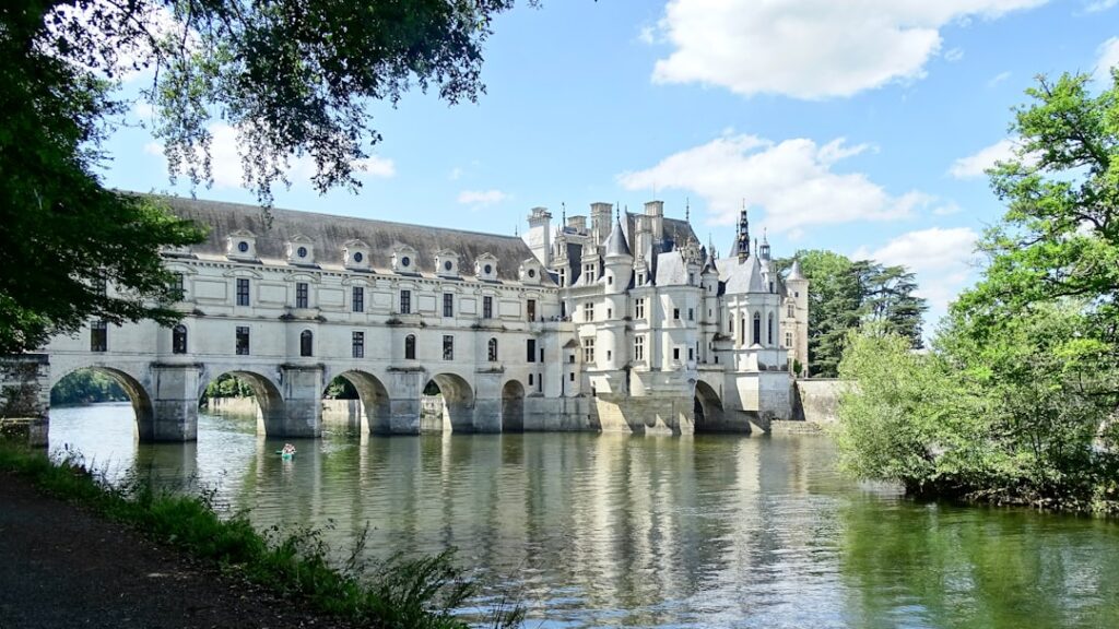 a large white building with a bridge over a body of water